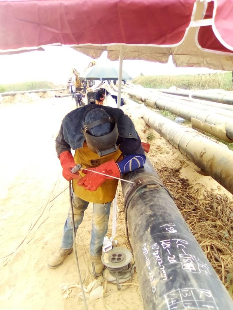 Field welding a pipeline section ahead of installation
